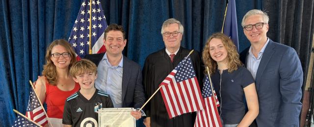 Judge Docherty and Naturalized citizens posing for a photo