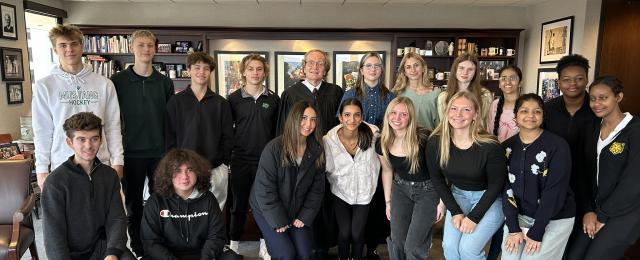 High school students posed for a photo with Judge Donovan Frank